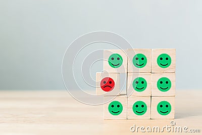 Wooden block with icon face emotion happiness and sadness, Unique, think different, individual and standing out from the crowd Stock Photo