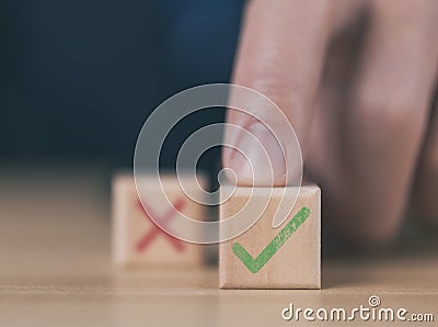 wooden block showing right and wrong sign decision concept, vote and think yes or no Business options for difficult situations Stock Photo