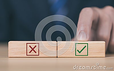 wooden block showing right and wrong sign decision concept, vote and think yes or no Business options for difficult situations Stock Photo