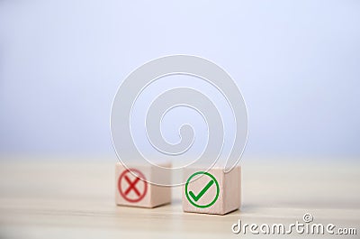 wooden block showing right and wrong sign decision concept, vote and think yes or no Business options for difficult situations Stock Photo