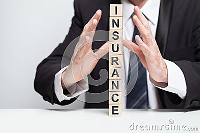 Wooden blocks with black word insurance, fragile pyramid, business insurance concept Stock Photo