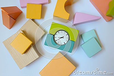 Wooden blocks with clock, top view. Early education, eco-friendly toys Stock Photo