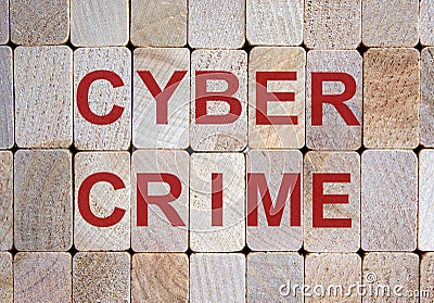 Wooden blocks form the word `cybercrime`. Beautiful wooden background Stock Photo