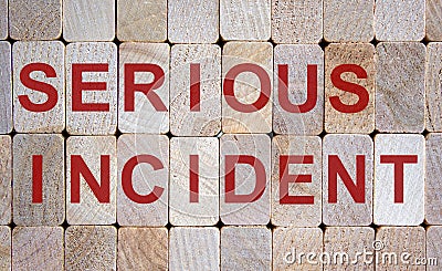 Wooden blocks form the words `serious incident`. Beautiful wooden background Stock Photo