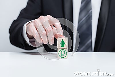 Wooden blocks with green currency ruble icon and green arrow up. Growth and depreciation concept Stock Photo