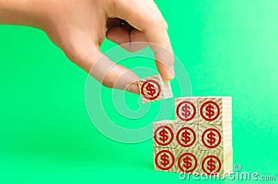 Wooden blocks with the image of dollars. concept of investment, investing money in business. increase of capital, payment of a loa Stock Photo