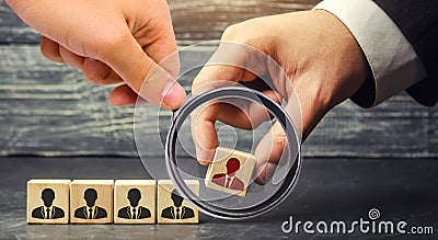 Wooden blocks with a picture of workers. the businessman or CEO removes / dismisses the employee. management within the team. Stock Photo