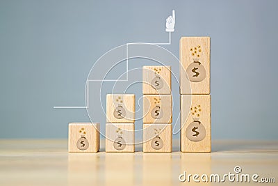 Wooden blocks stacking as step stair with Money bag growing, concept of taxation in savings Stock Photo