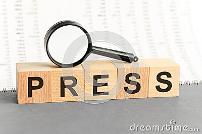Wooden blocks with the text: press with magnifying glass Stock Photo