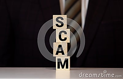 Wooden Blocks with the text: Scam Stock Photo