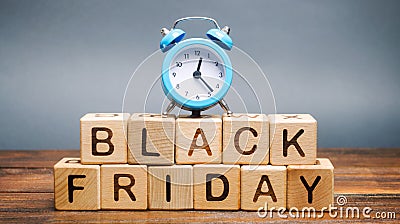 Wooden blocks with the word Black Friday and the clock. Sale and discounts. Low prices. Thanksgiving Day Stock Photo