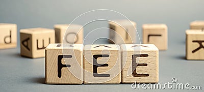Wooden blocks with the word Fee and randomly scattered cubes. Fixed price charged for a specific service. Business and finance Stock Photo