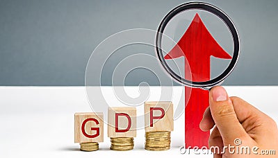 Wooden blocks with the word GDP and up arrow. Technological progress, increasing the level of workers, improving the allocation of Stock Photo