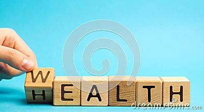 Wooden blocks with the word Health and Wealth. Concept of choosing priority in life and lifestyle. Make the right choice. Life Stock Photo