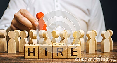 Wooden blocks with the word Hire. Headhunter selects a person from the crowd. Human Resource Management. Recruiting Headhunting. Stock Photo