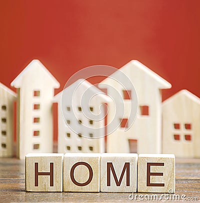 Wooden blocks with the word Home and miniature houses. Stock Photo