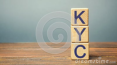 Wooden blocks with the word KYC - Know Your Customer / Client. Verify the identity, suitability and risks involved with Stock Photo