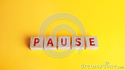 Wooden blocks with the word Pause. Break time concept. A break during work. Time to relax and recharge. Stop the business process Stock Photo