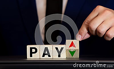 Wooden blocks with the word PAY, money and a forklift Stock Photo