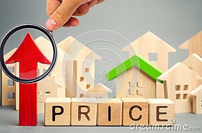 Wooden blocks with the word Price, up arrow and wooden houses. The increase in housing prices. Rising rent for an apartment. The Stock Photo