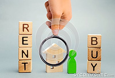 Wooden blocks with the word Rent or buy and a person stands near the house. Make the right decision. Real estate concept. Rent Stock Photo