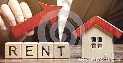 Wooden blocks with the word Rent, house and up arrow. The concept of the high cost of rent for an apartment or home. Interest Stock Photo