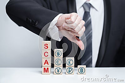 Wooden blocks with word scam and currency icons. Businessman thumb down, Business fraud, scam, crime concept Stock Photo