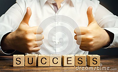 Wooden blocks with the word Success and businessman. Successful business concept. Achieving the goal, overcoming difficulties. The Stock Photo