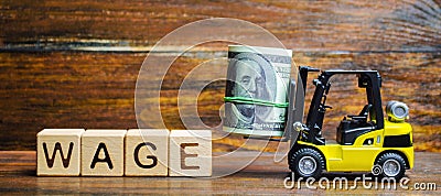 Wooden blocks with the word Wage, dollars and a forklift. Financial compensation. Salary payment to employees. Minimum and nominal Stock Photo