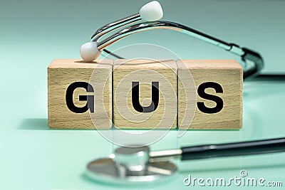 Wooden blocks with the words GUS, urogenital system, medical stethoscope, health concept, regular examinations Stock Photo