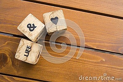 Wooden blocks with the words lie on the table. Wooden cubes with letters and symbols. Stock Photo