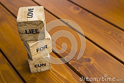 Wooden blocks with the words lie on the table. Wooden cubes with letters and symbols. Life for love Stock Photo