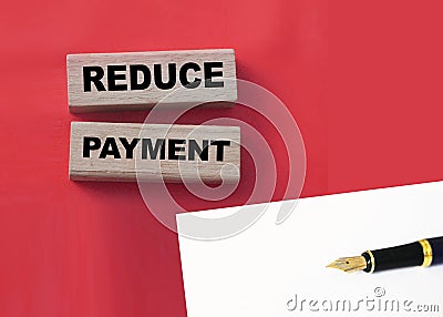 Wooden blocks with the words Reduce payment. Business concept Stock Photo
