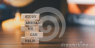 Wooden blocks with words 'Study Abroad? We Can Help! Concept of global business study, abroad educational, Back to School. Stock Photo