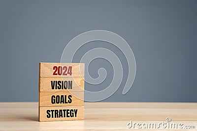 Wooden blocks with words 2024 vision, goals, strategy. Setting goal, target for next year. Plans and tasks. Financial management Stock Photo