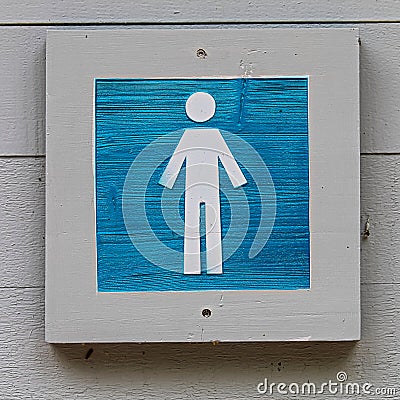 A wooden blue male bathroom sign Stock Photo