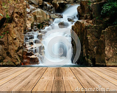 Wooden board empty table blur waterfall in forest - can be used for display or montage your products. Stock Photo