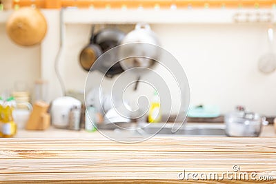 Wooden board empty table in front of Blur image of traditional Kitchen Room Stock Photo