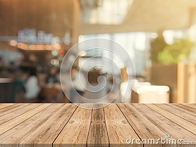 Wooden board empty table top on of blurred background. Perspective brown wood table over blur in coffee shop background Stock Photo