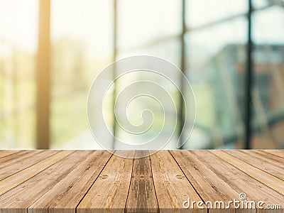 Wooden board empty table top on of blurred background. Perspective brown wood table over blur in coffee shop background. Stock Photo