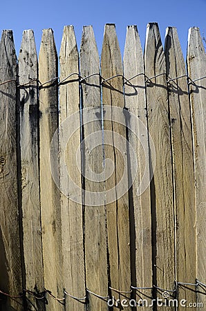 WOODEN BOARD FENCE CONNECTED BY WIRE Stock Photo