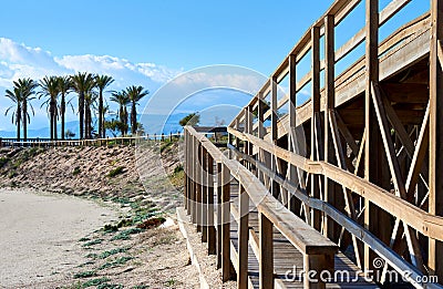 Wooden boardwalk leading to the Retamar beach Stock Photo