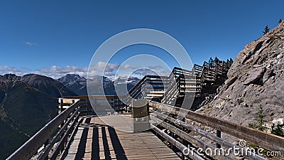 Wooden boardwalk leading to the top of Sulphur Mountain near Banff, Banff National Park, Canada with Rocky Mountains. Stock Photo