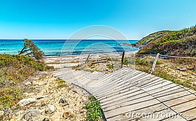 Wooden boardwalk in Scoglio di Peppino beach Stock Photo