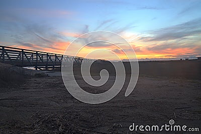 Wooden Boardwalk at sunset at Bolsa Chica Stock Photo