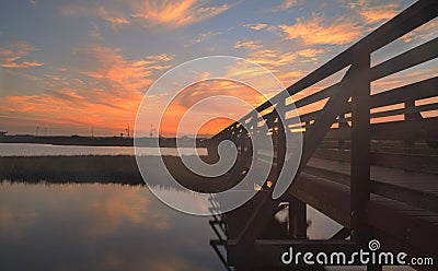 Wooden Boardwalk at sunset at Bolsa Chica Stock Photo