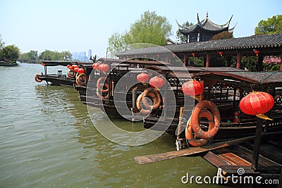 Wooden boat anchoring bank with its refelctor Editorial Stock Photo