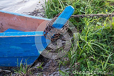 Nose of wooden old blue boat, close-up view from the nose, stands on the green grass, tethered metal chain Stock Photo