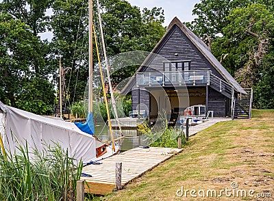 Wooden boat shed on the Norfolk Broads, UK Editorial Stock Photo