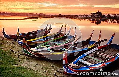 Wooden boat in Ubein Bridge at sunrise, Mandalay, Myanmar Stock Photo